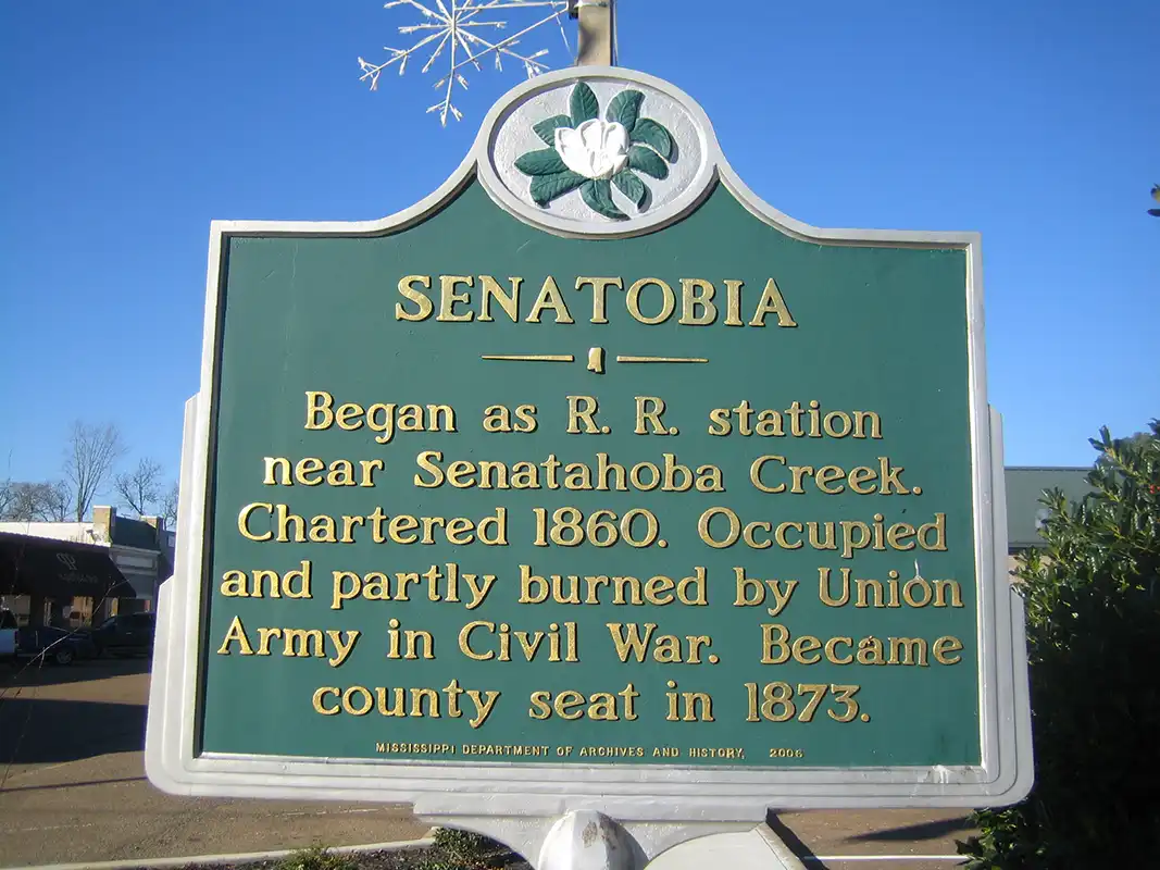 The name “Senatobia” was derived from the Indian word “ Senatohoba ,” which means “white Sycamore” and is a symbol of “ rest for the weary.”This marker is at the corner of W. Main St. and S. Front St.