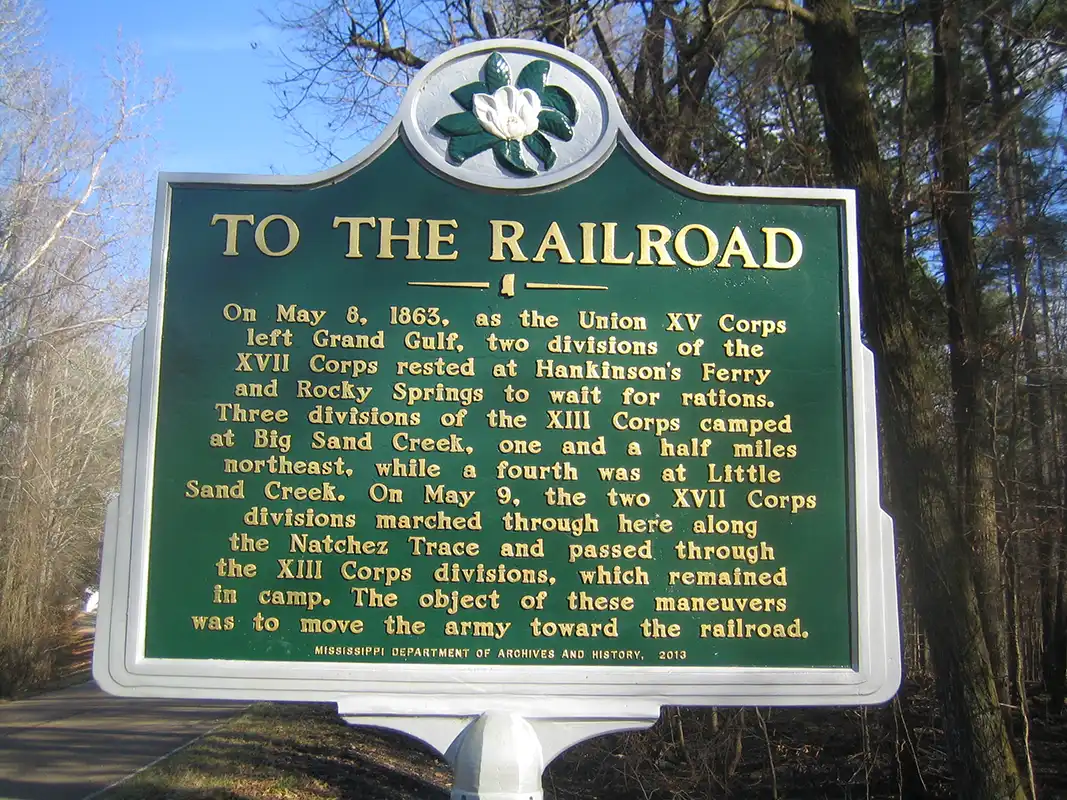 This marker, To the Railroad, is at Old Port Gibson Road at Old Natchez Trace Roadbed, about 350 yards west of Midway Road.