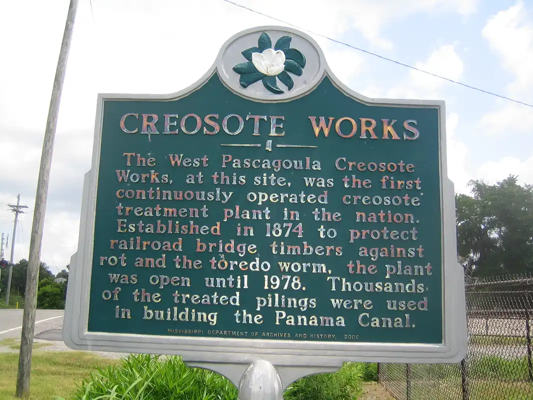 This marker for Creosote Works is next to the railroad track at the intersection of Graveline Road and Old Spanish Trail in Gautier.