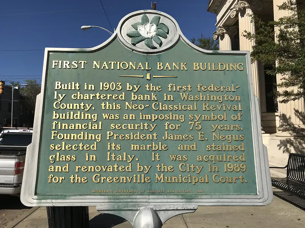 The First National Bank Building marker is located on the corner of Main and Poplar Street in downtown Greenville.