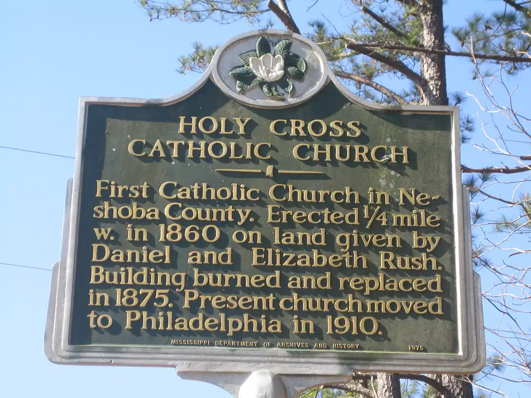 The Holy Cross Catholic Church marker is on Highway 21 at County Road 2628, about 4.5 miles north of Philadelphia.