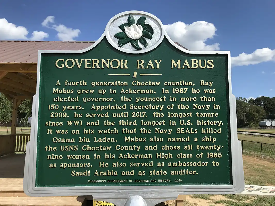 The Governor Ray Mabus marker is in Governor's Park in downtown Ackerman at the corner of E. Main St. and S. Commerce St.