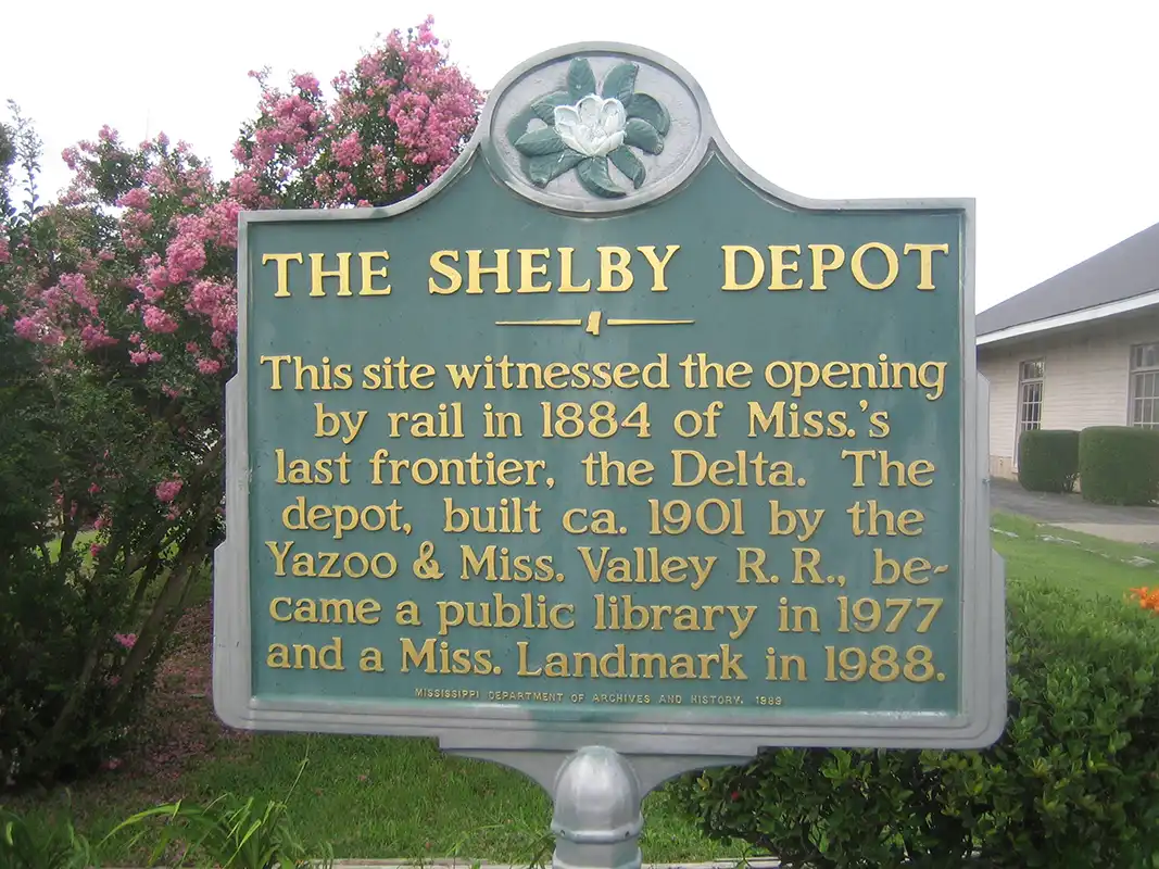 The Shelby Depot marker is at the corner of S. Broadway and W. 2nd Avenue in Shelby.