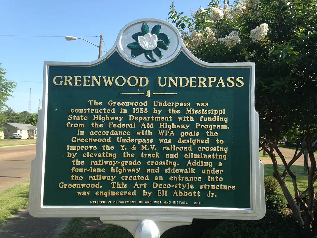 The Greenwood Underpass marker is located at about 1300 Main Street, near the intersection with W. Martin Luther King Dr.